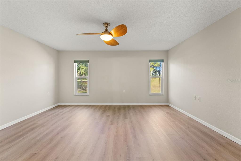 1415 Pinewood Hills Court Spring Hill, FL 34606 - Photo 23 of 45 an empty room with wooden floor and window