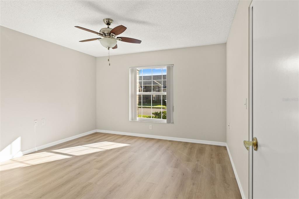1415 Pinewood Hills Court Spring Hill, FL 34606 - Photo 29 of 45 a view of empty room with wooden floor and fan