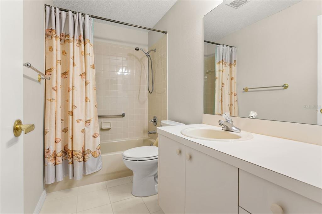 1415 Pinewood Hills Court Spring Hill, FL 34606 - Photo 30 of 45 a bathroom with a sink toilet a shower and a mirror