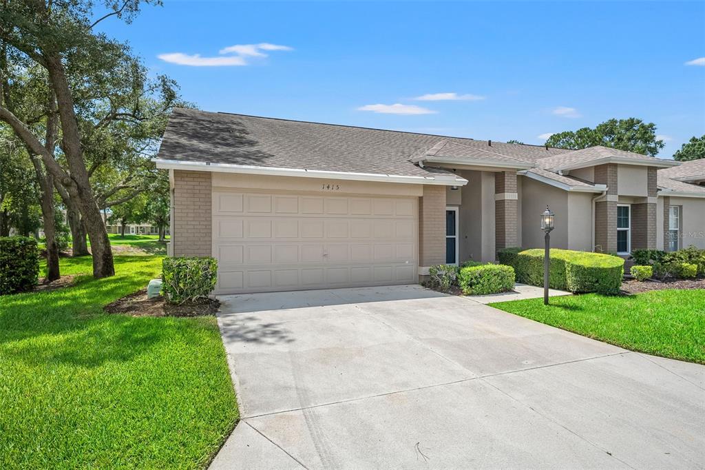 1415 Pinewood Hills Court Spring Hill, FL 34606 - Photo 4 of 45 a view of a house with a yard