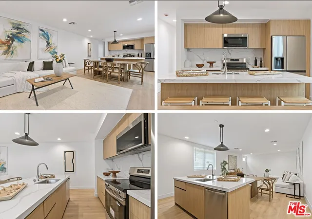 a view of kitchen with kitchen island stainless steel appliances a sink and counter space