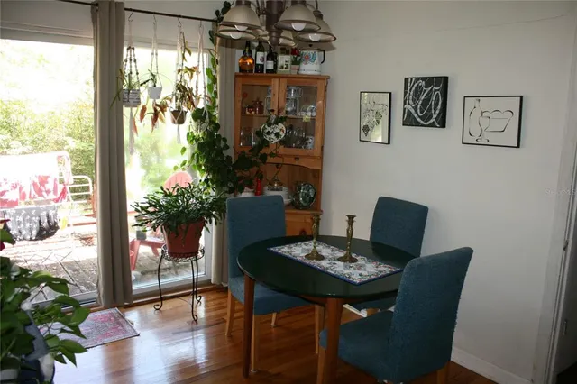 a view of a dining room with furniture window and wooden floor