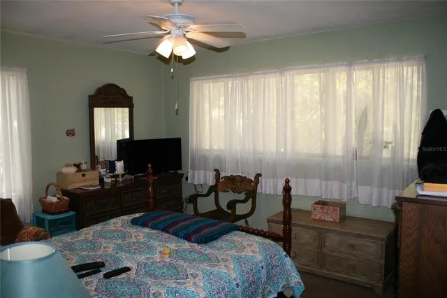 a bedroom with a bed and a television