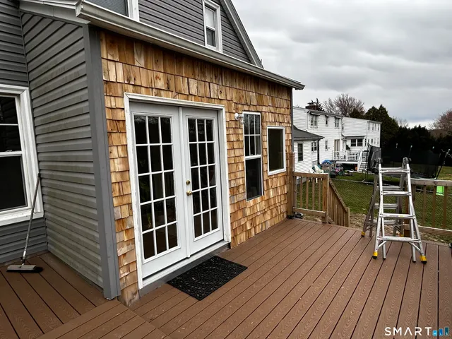 a view of a house with a large window and wooden floor