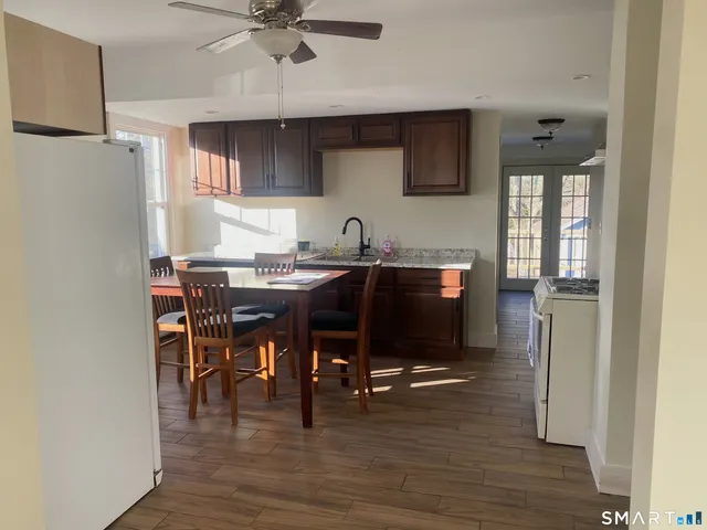 a view of a dining room with furniture and wooden floor