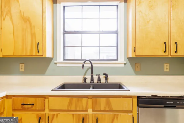 a kitchen with a sink and a window