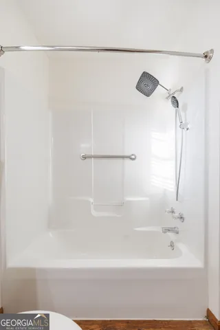 a bathroom with a shower and a bath tub