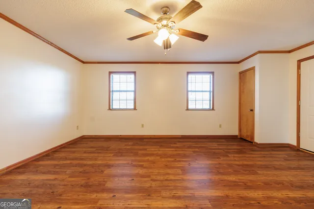 wooden floor in an empty room with a window
