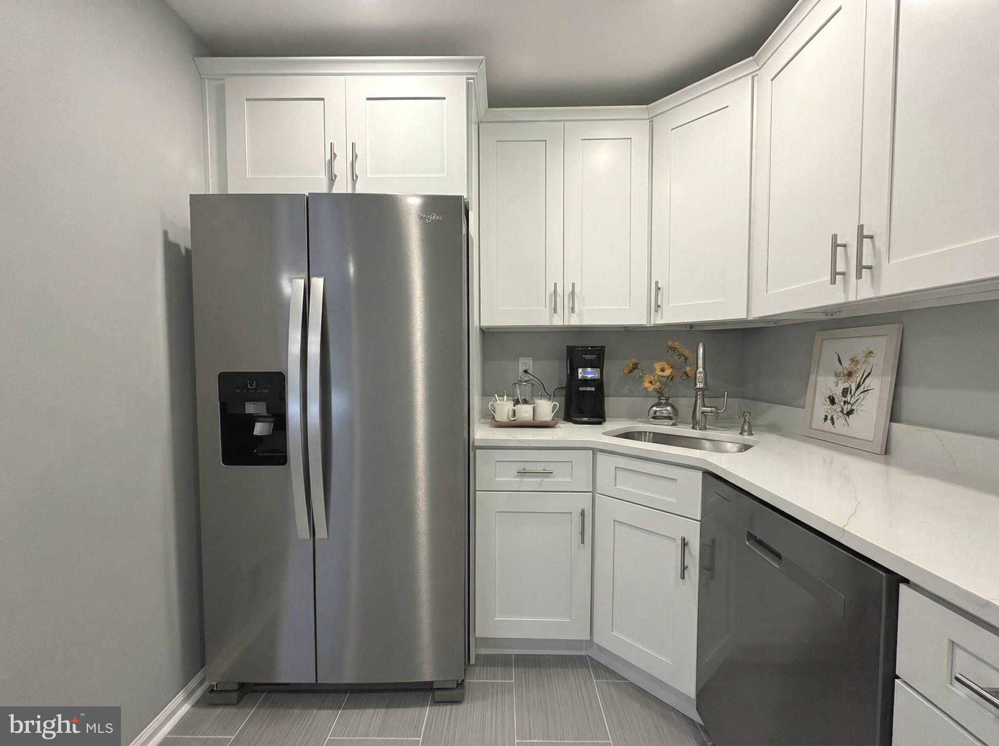 205 Castleton Court Pennington, NJ 08534 - Photo 12 of 26 a kitchen with stainless steel appliances granite countertop a refrigerator sink and cabinets
