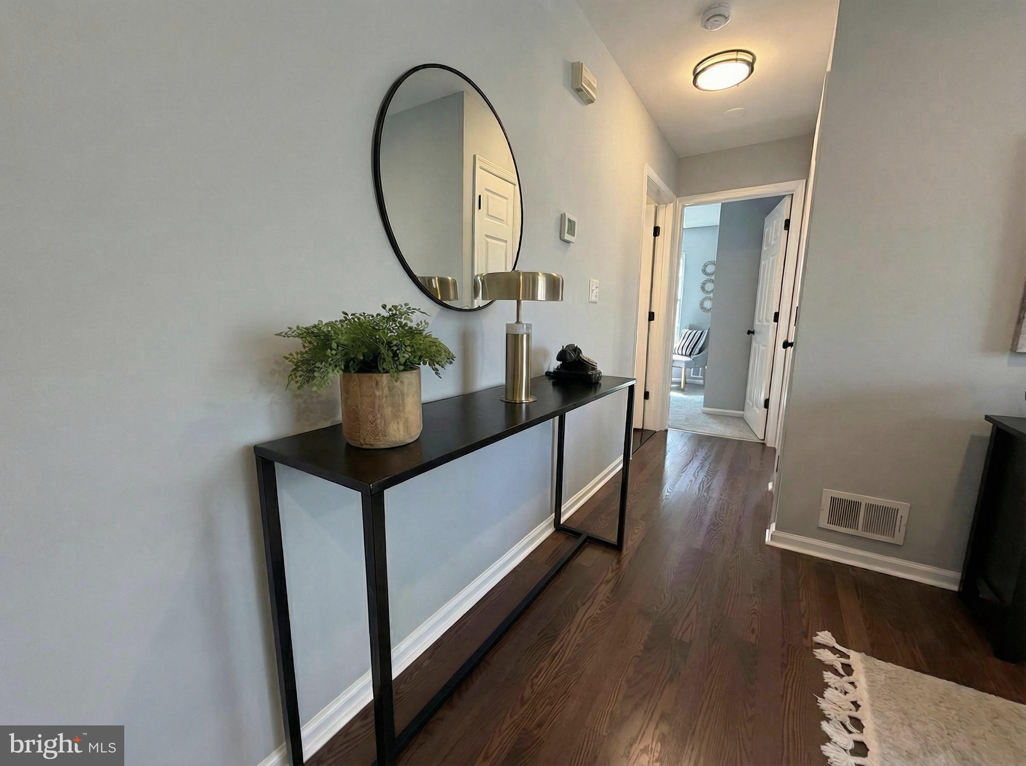 205 Castleton Court Pennington, NJ 08534 - Photo 13 of 26 a living room with furniture and a mirror