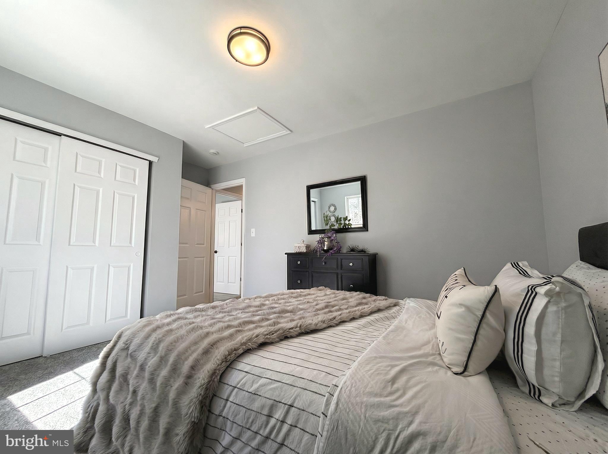 205 Castleton Court Pennington, NJ 08534 - Photo 16 of 26 a bedroom with a bed and a lamp