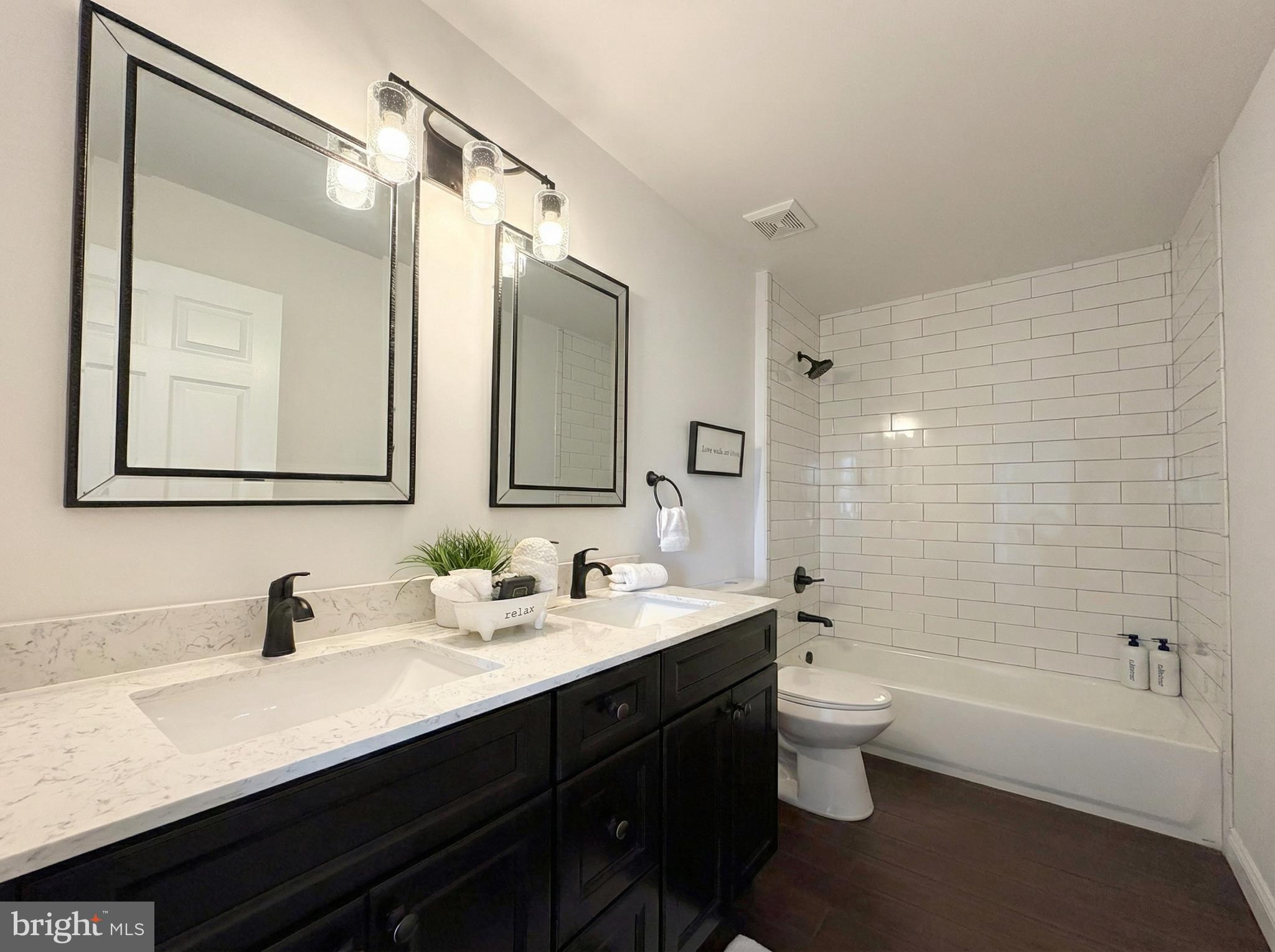205 Castleton Court Pennington, NJ 08534 - Photo 17 of 26 a bathroom with a double vanity sink toilet mirror and bathtub