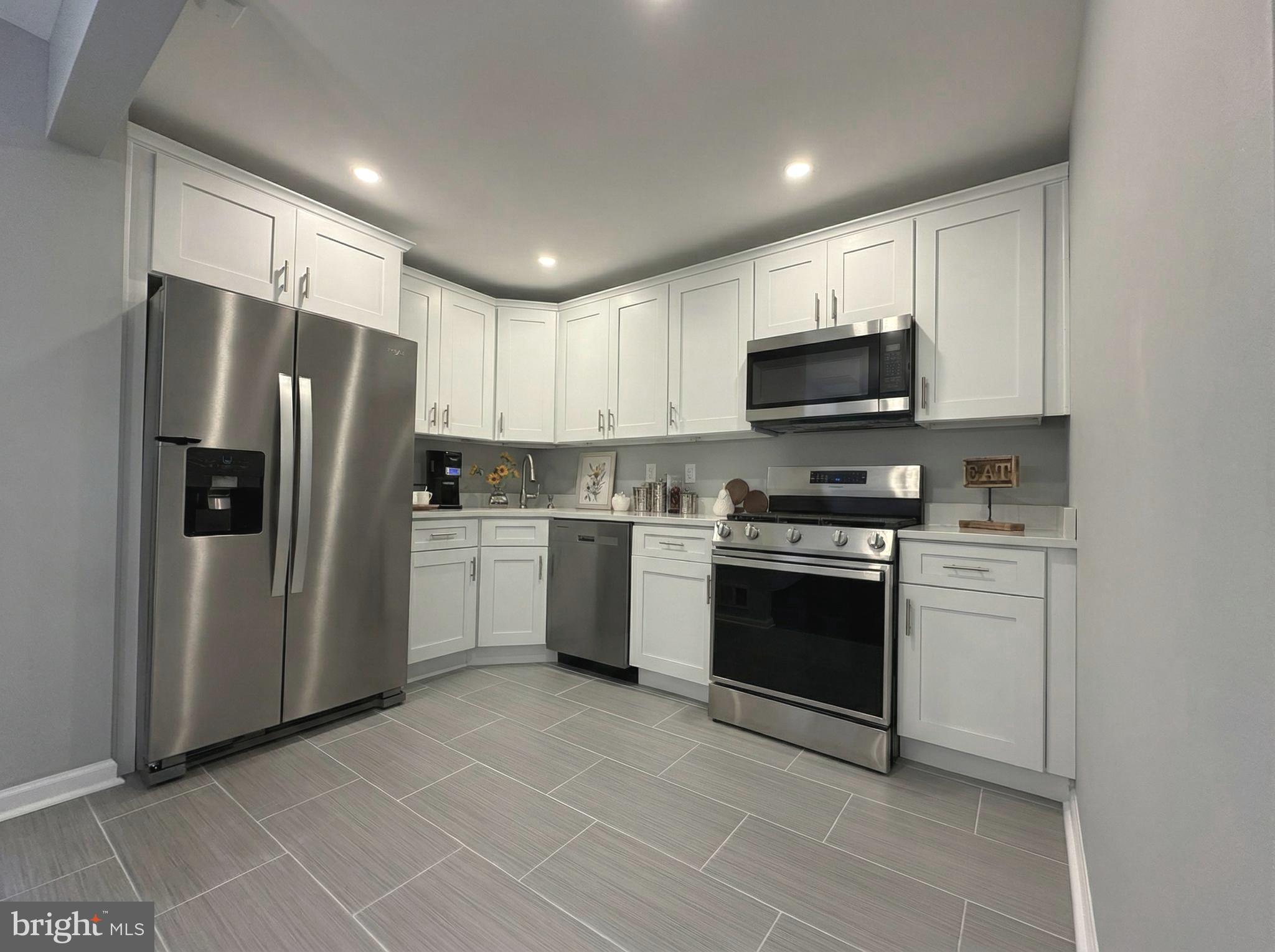 205 Castleton Court Pennington, NJ 08534 - Photo 8 of 26 a kitchen with a stove a sink and a refrigerator