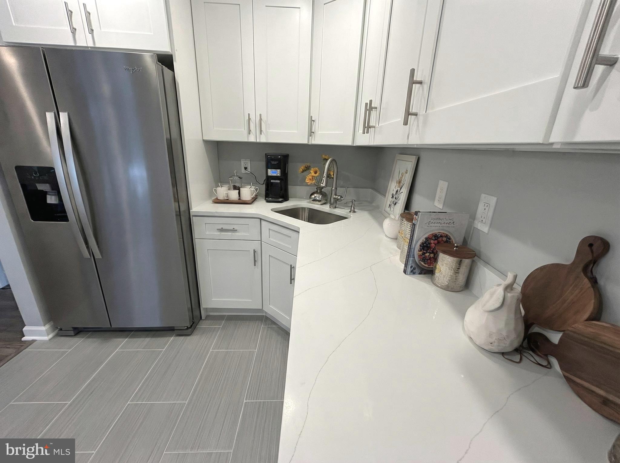 205 Castleton Court Pennington, NJ 08534 - Photo 9 of 26 a kitchen with a refrigerator and cabinets