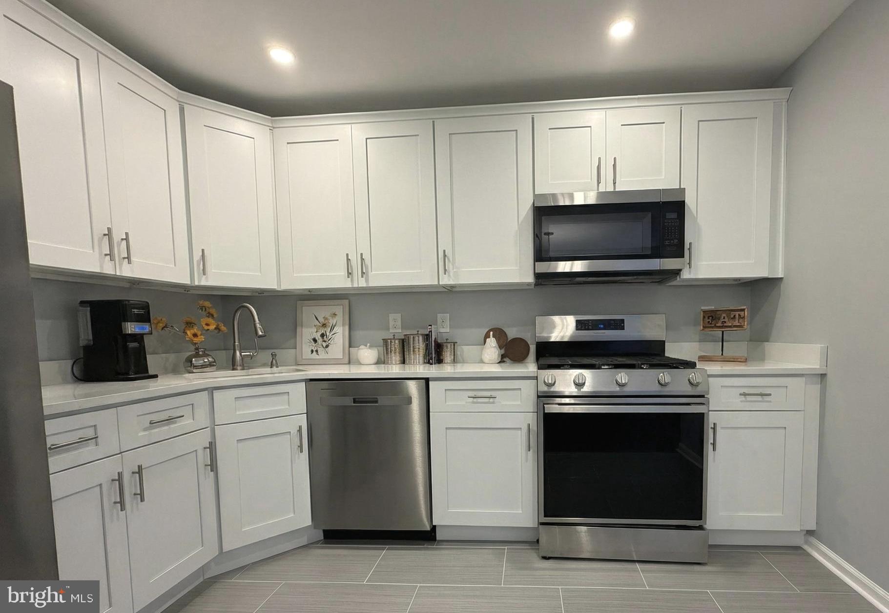 205 Castleton Court Pennington, NJ 08534 - Photo 10 of 26 a kitchen with white cabinets and stainless steel appliances
