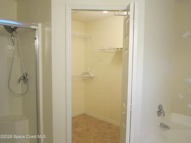 a bathroom with a glass shower door