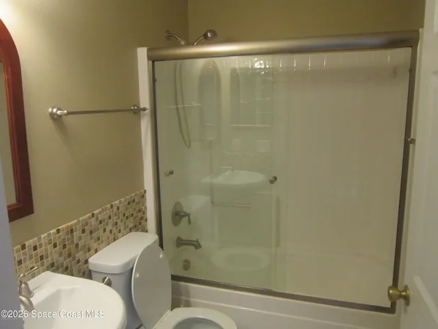 a bathroom with a shower and a toilet