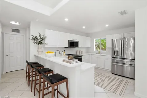 a kitchen with a refrigerator and a stove top oven