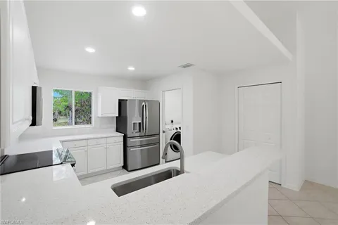 a kitchen with stainless steel appliances a refrigerator and a stove top oven