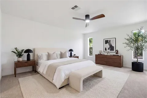a bedroom with bed and a potted plant