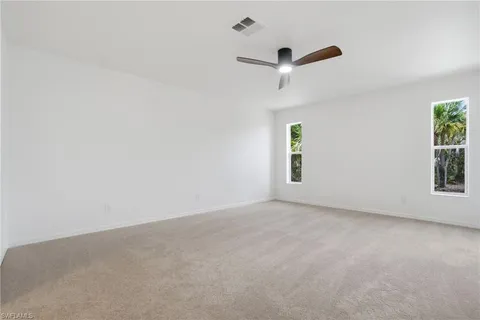 an empty room with windows and closet