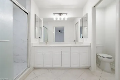 a bathroom with a sink vanity and toilet