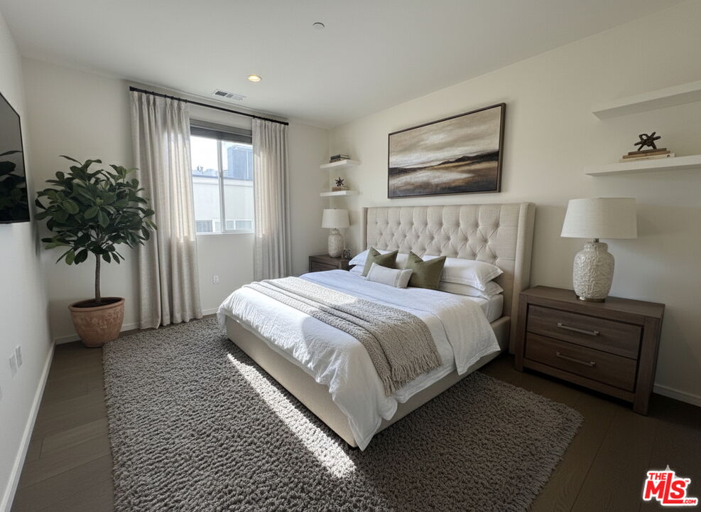 11764 Idaho Avenue, Unit 301 Los Angeles, CA 90025 - Photo 11 of 20 a bedroom with a bed and a potted plant