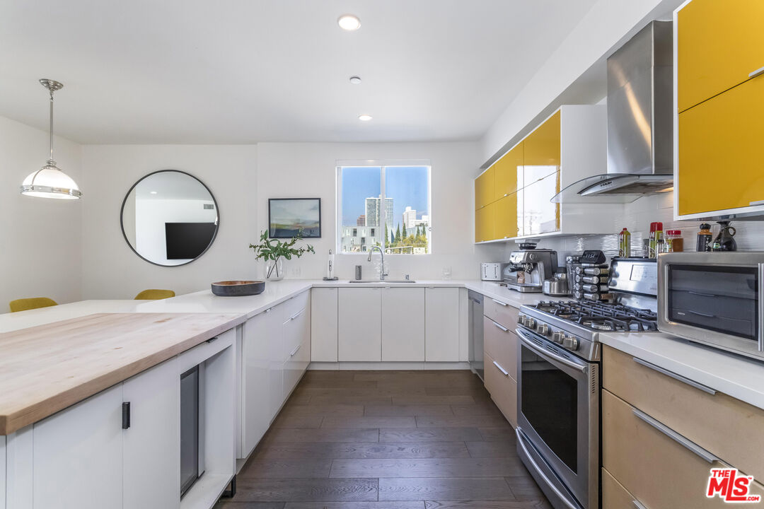 11764 Idaho Avenue, Unit 301 Los Angeles, CA 90025 - Photo 3 of 20 a kitchen with a sink stove and cabinets