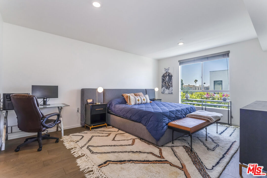 11764 Idaho Avenue, Unit 301 Los Angeles, CA 90025 - Photo 8 of 20 a bedroom with a bed a desk and chair