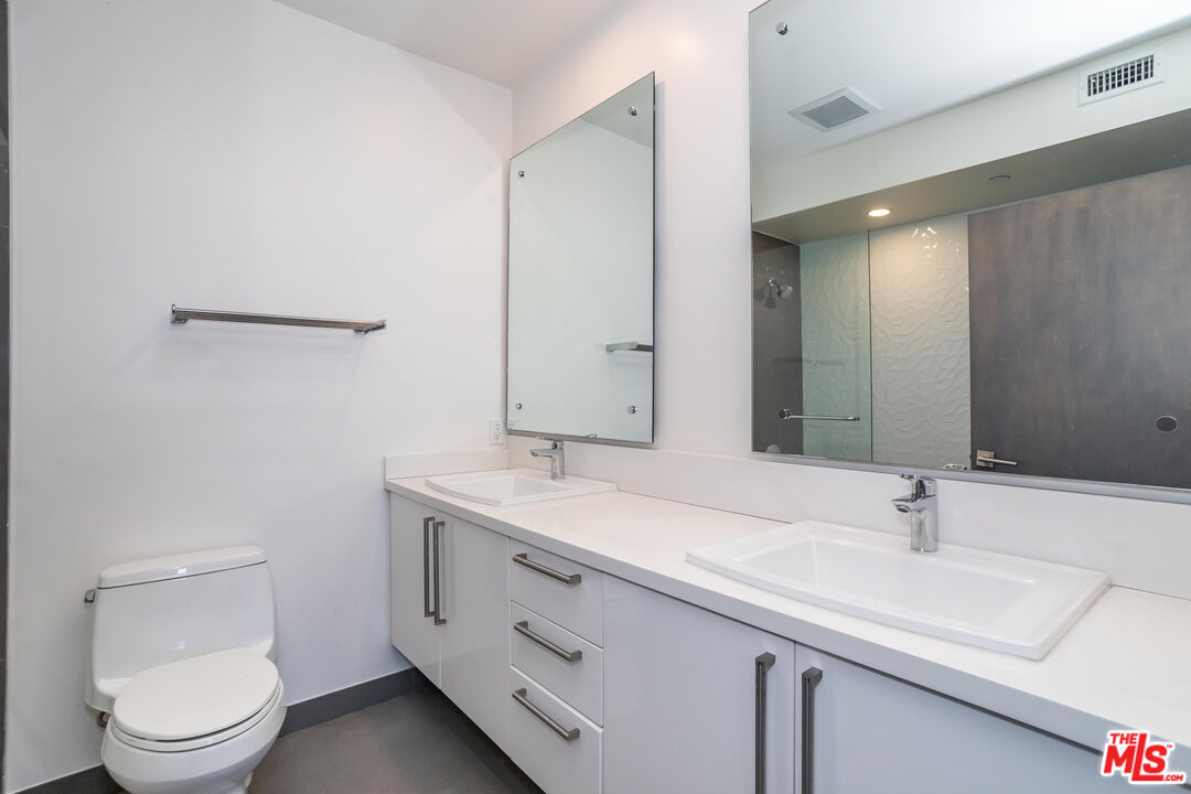 11764 Idaho Avenue, Unit 301 Los Angeles, CA 90025 - Photo 9 of 20 a bathroom with a sink a toilet and mirror