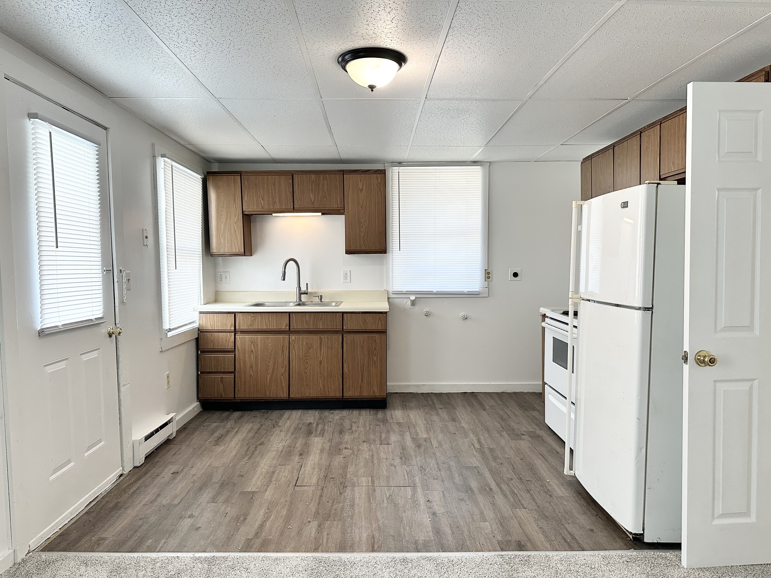 123 High Street Sprague, CT 06330 - Photo 3 of 11 a kitchen with a sink a refrigerator a counter top space and cabinets