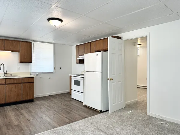 a kitchen with white cabinets and white appliances