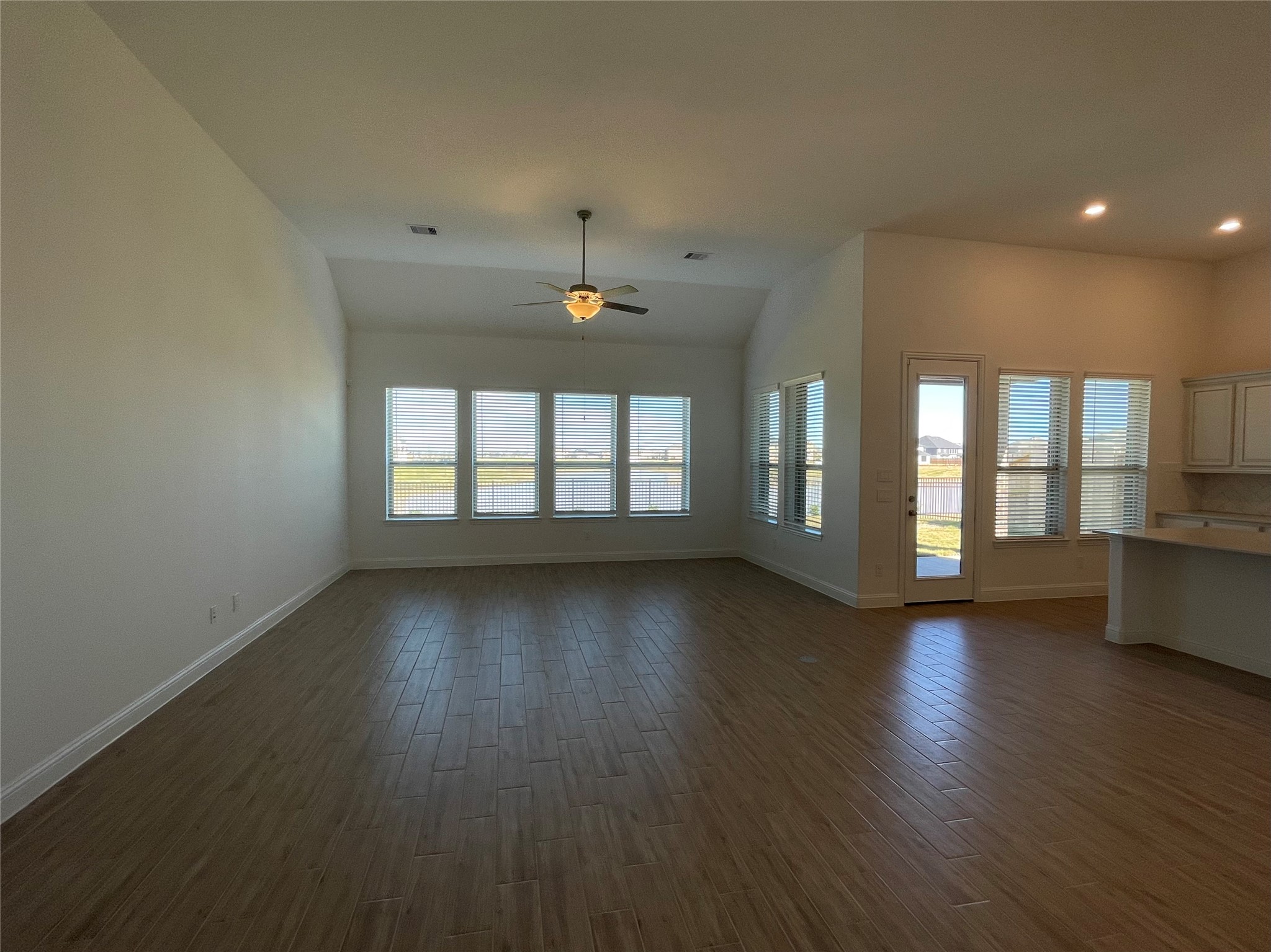 29806 Cherry Vine Road Katy, TX 77494 - Photo 8 of 30 a view of an empty room with wooden floor and a window