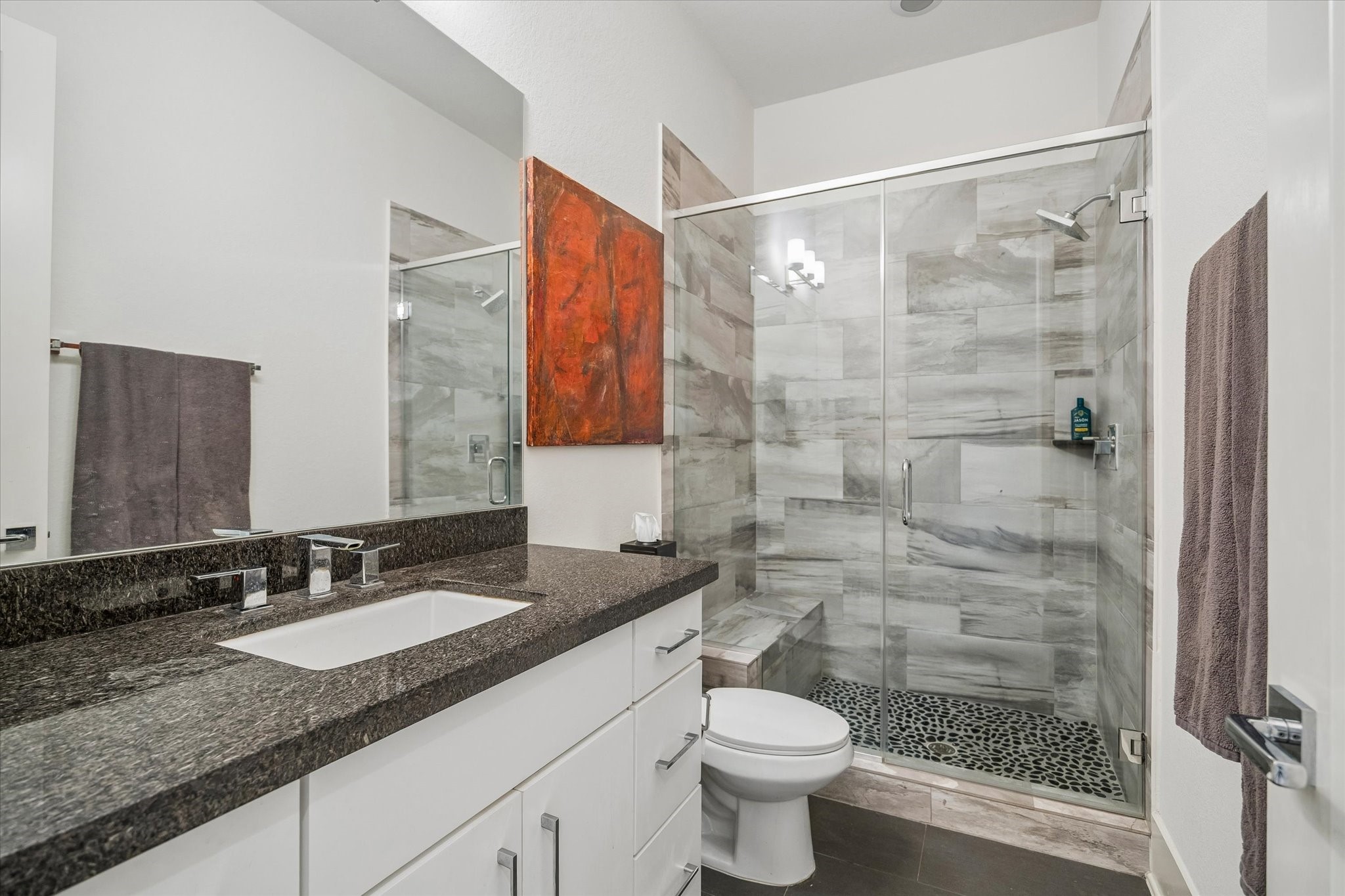 1526 Vermont Street Houston, TX 77006 - Photo 12 of 39 Well-appointed first-floor full bath with stone counters and a glass-enclosed walk-in shower.