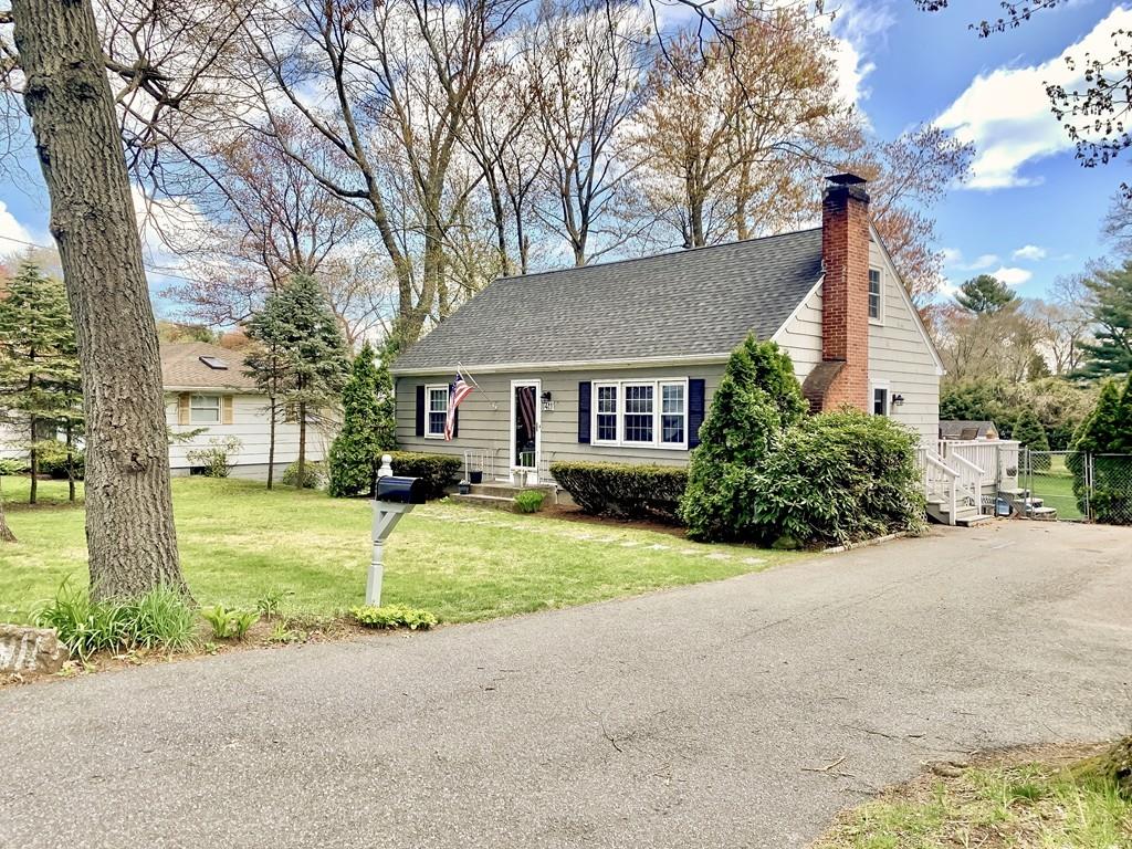 411 Dwight Road East Longmeadow, MA 01028 - Photo 2 of 34 a front view of a house with a garden and trees