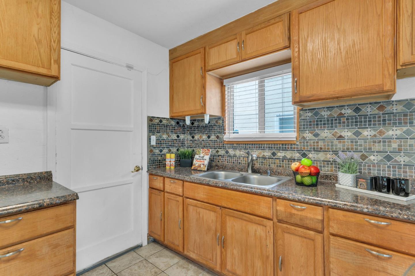 809 Modoc Street Vallejo, CA 94591 - Photo 12 of 31 a kitchen with stainless steel appliances granite countertop a sink and a white cabinets