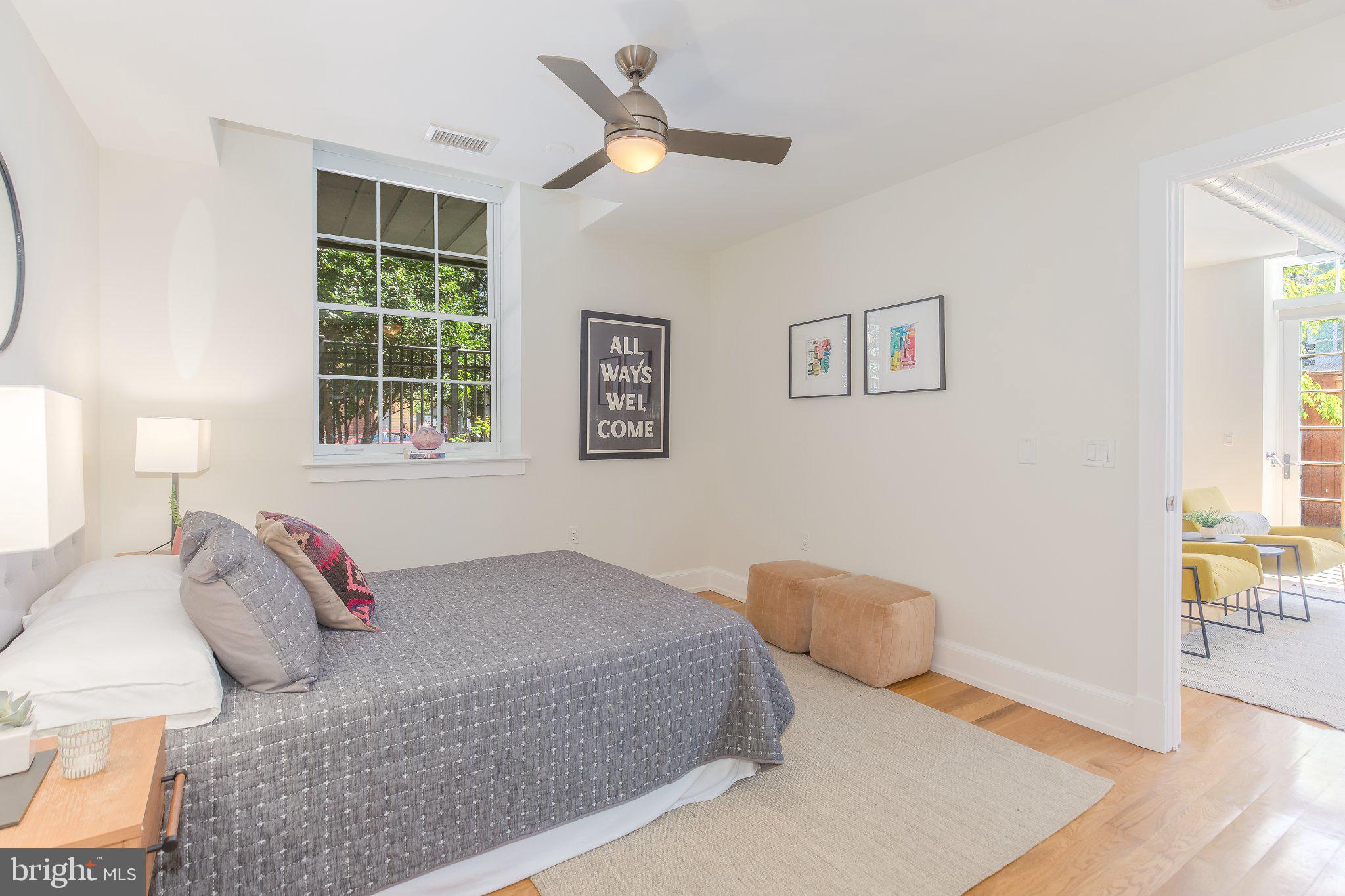 215 I Street Northeast, Unit 105 Washington, DC 20002 - Photo 22 of 41 a bedroom with a bed and wooden floor