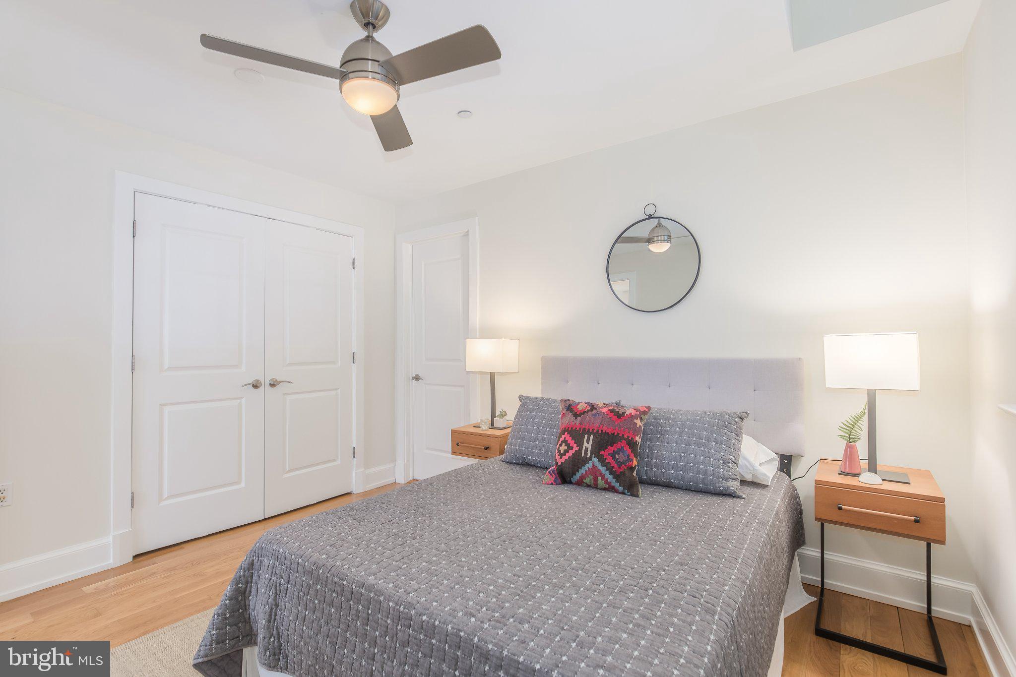 215 I Street Northeast, Unit 105 Washington, DC 20002 - Photo 23 of 41 a bedroom with a bed and a lamp
