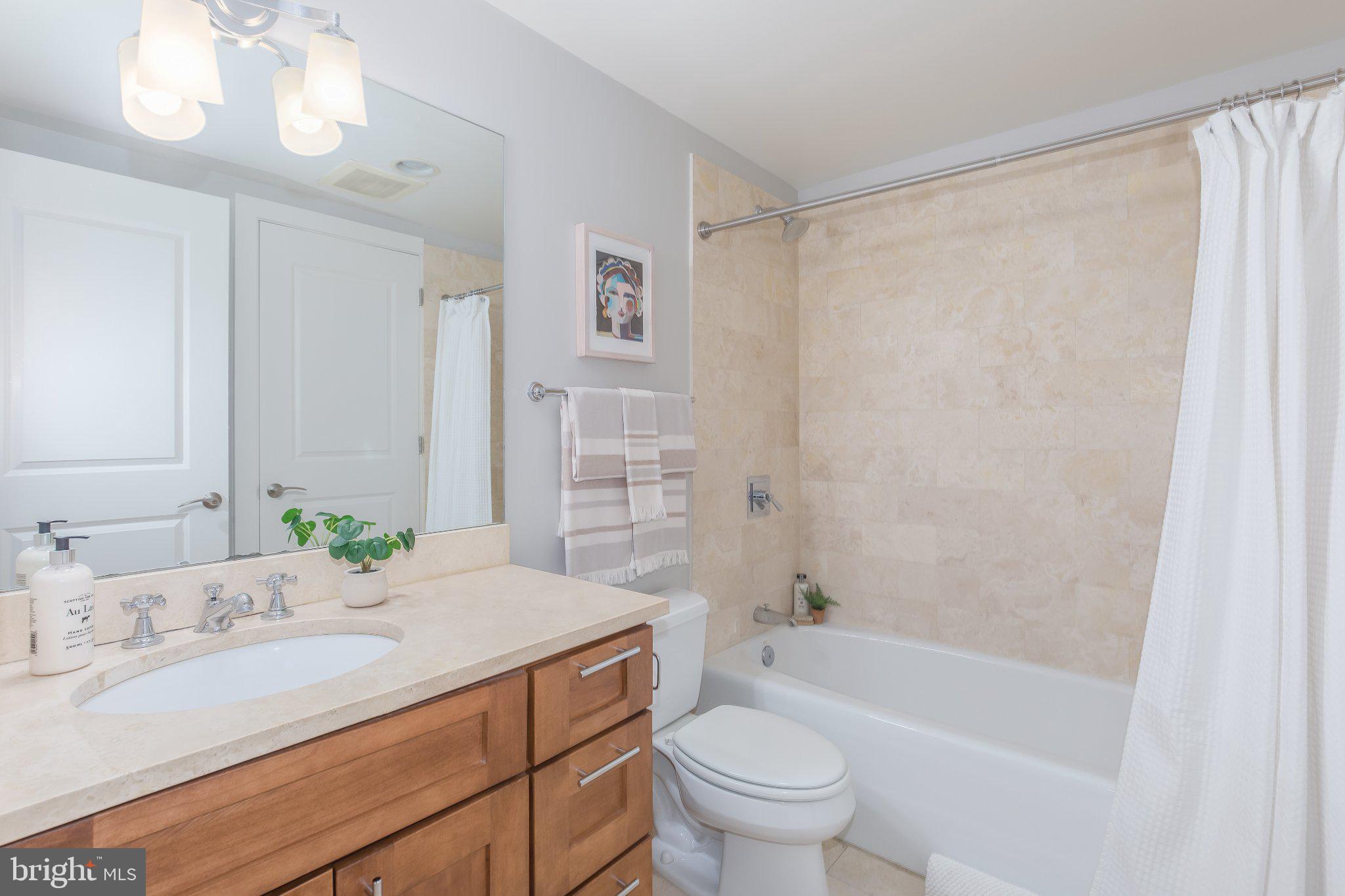 215 I Street Northeast, Unit 105 Washington, DC 20002 - Photo 24 of 41 a bathroom with a sink toilet and shower
