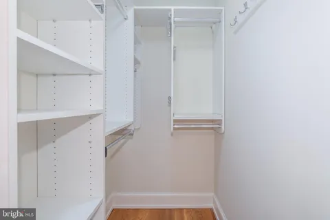a view of walk in closet with white walls