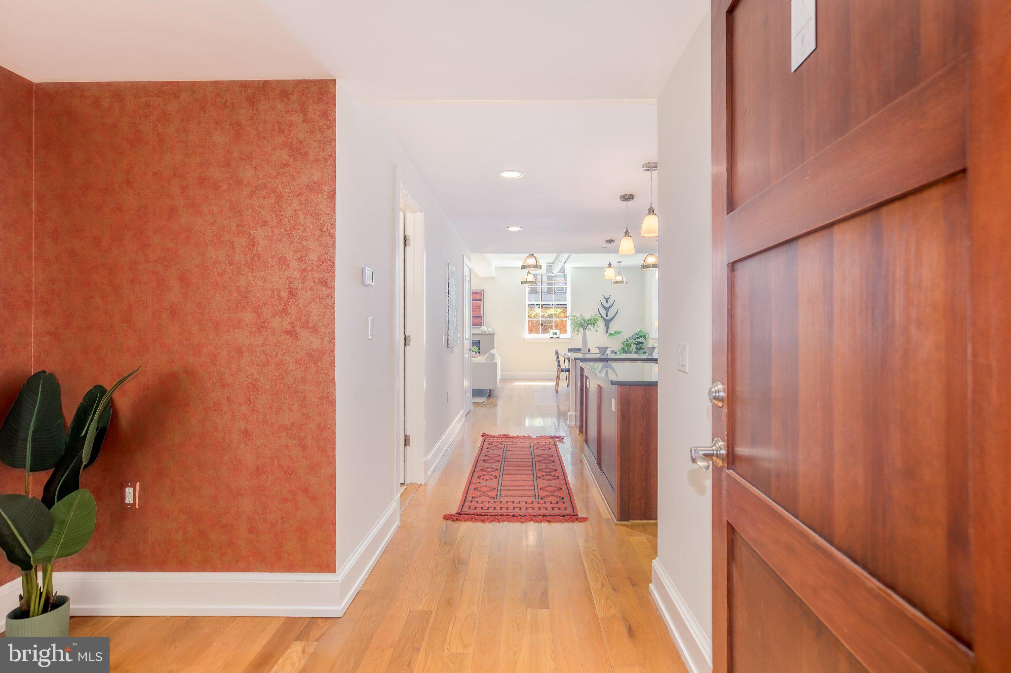 215 I Street Northeast, Unit 105 Washington, DC 20002 - Photo 33 of 41 a view of a hallway with wooden floor and a bathroom