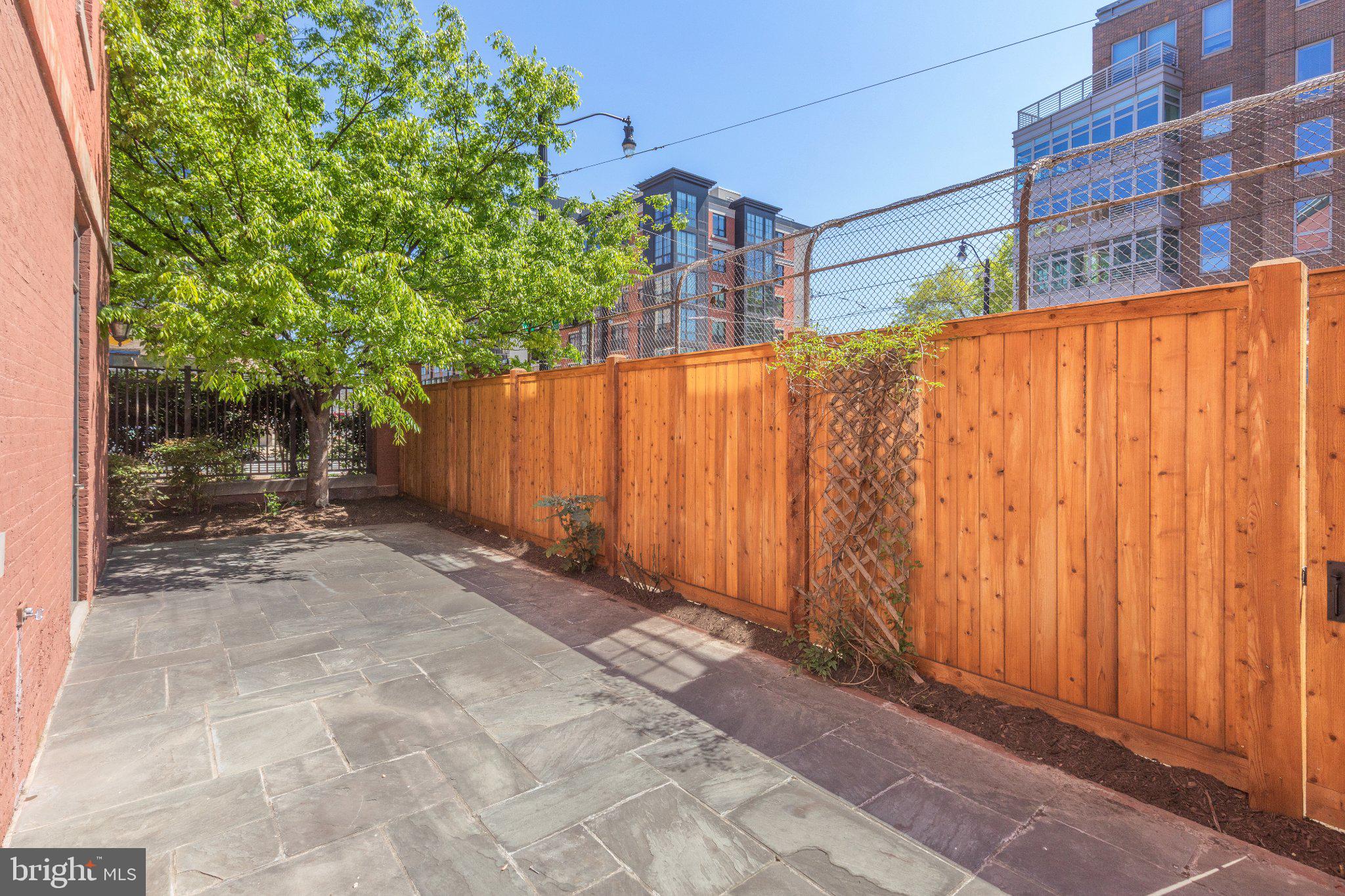 215 I Street Northeast, Unit 105 Washington, DC 20002 - Photo 37 of 41 a view of a back yard with a wooden fence