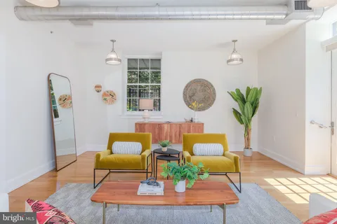 a living room with furniture rug and window