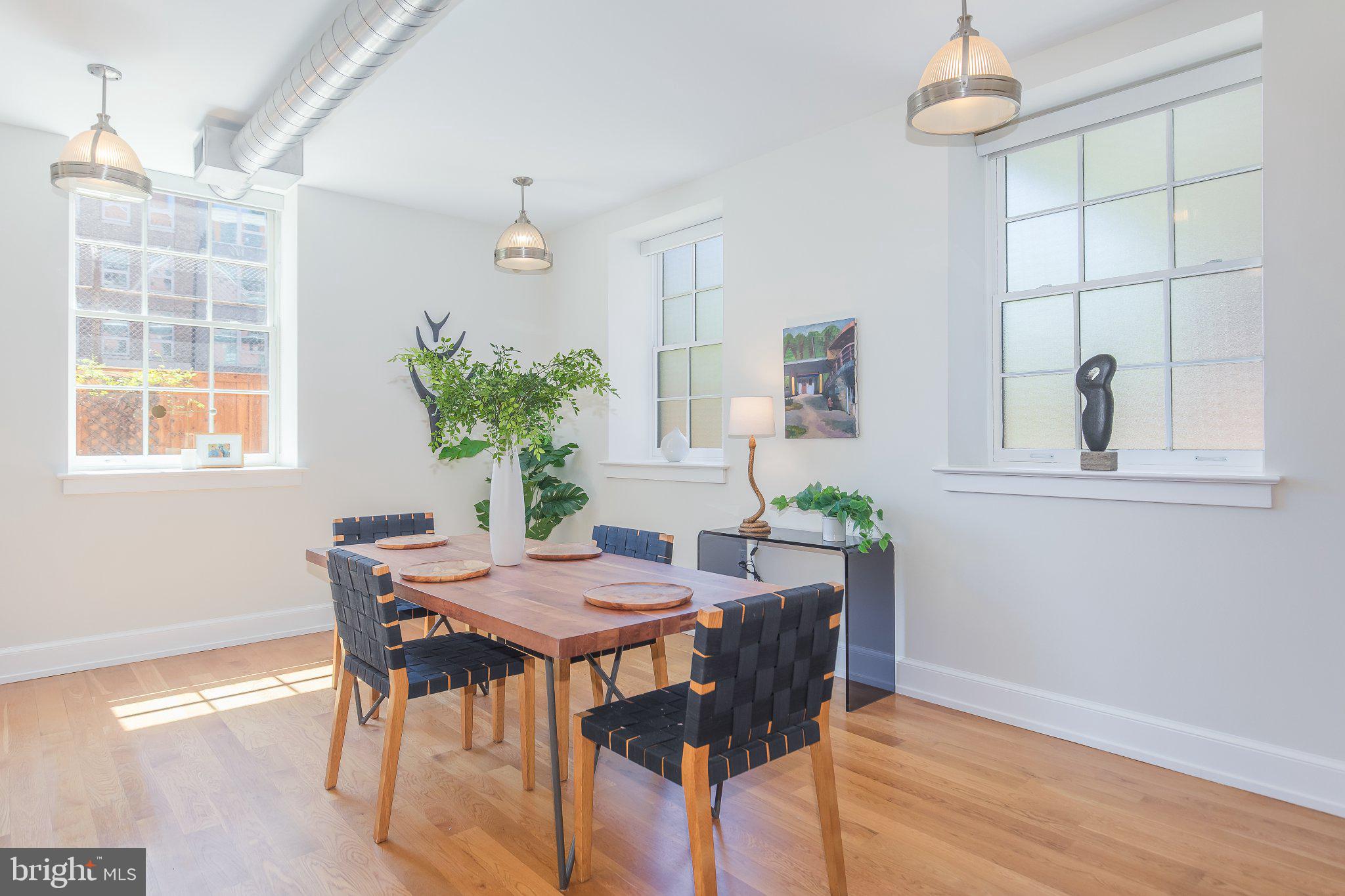 215 I Street Northeast, Unit 105 Washington, DC 20002 - Photo 8 of 41 a view of a dining room with furniture and a potted plant