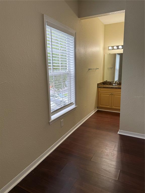 3725 Conroy Road, Unit 2127 Orlando, FL 32839 - Photo 22 of 30 wooden floor in an empty room with a window