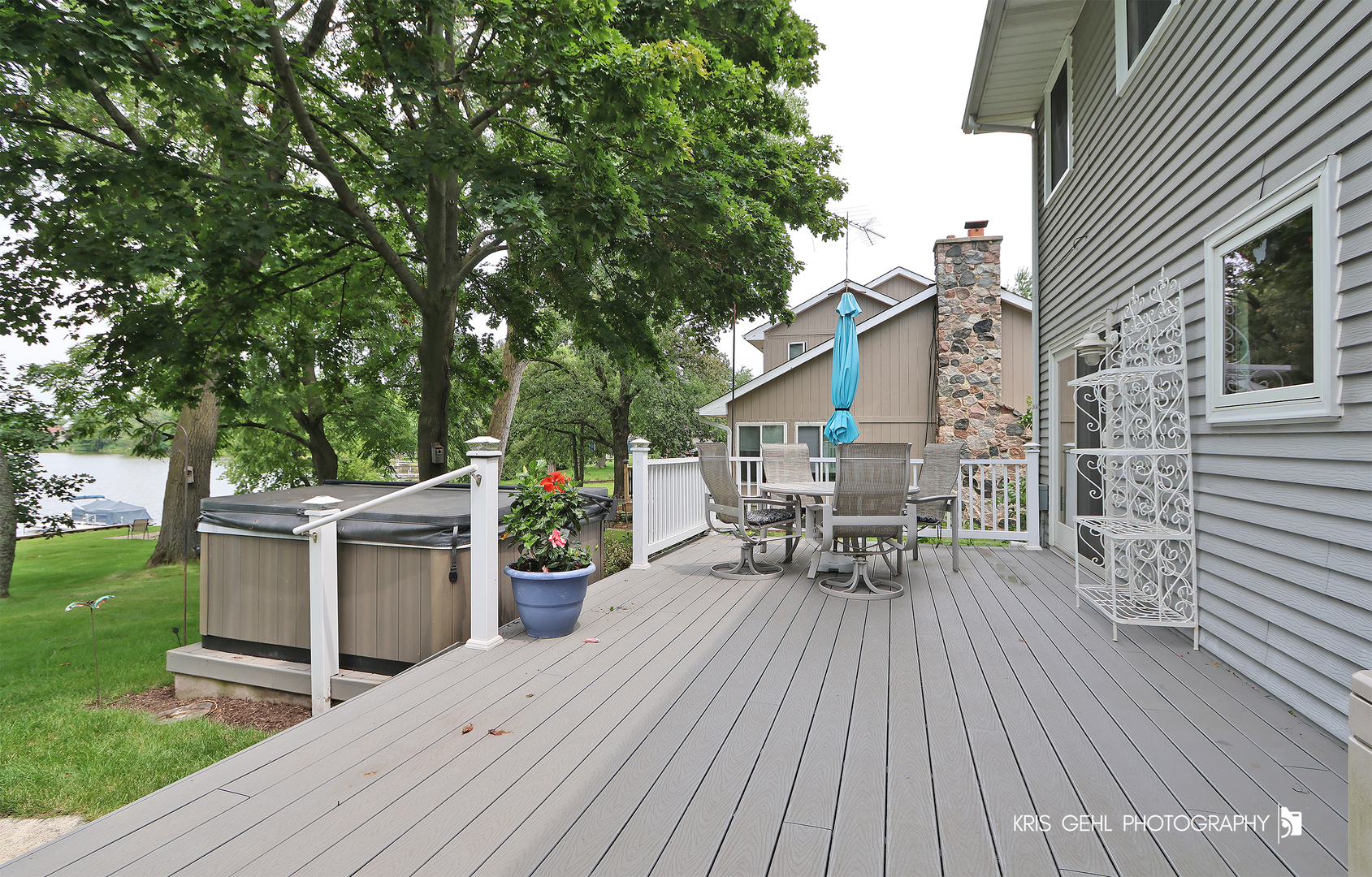526 Whispering Pines Road Lindenhurst, IL 60046 - Photo 25 of 38 a view of a roof deck with table and chairs wooden floor and fence