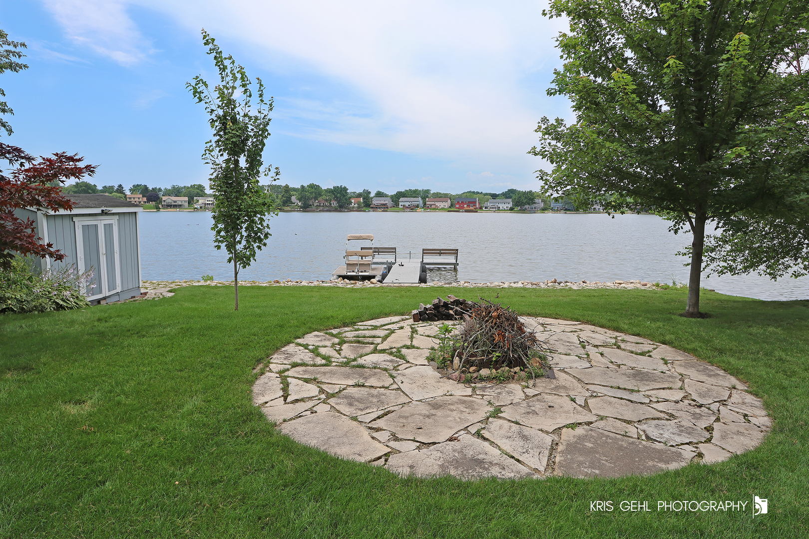 526 Whispering Pines Road Lindenhurst, IL 60046 - Photo 28 of 38 a view of a backyard with plants and lake view