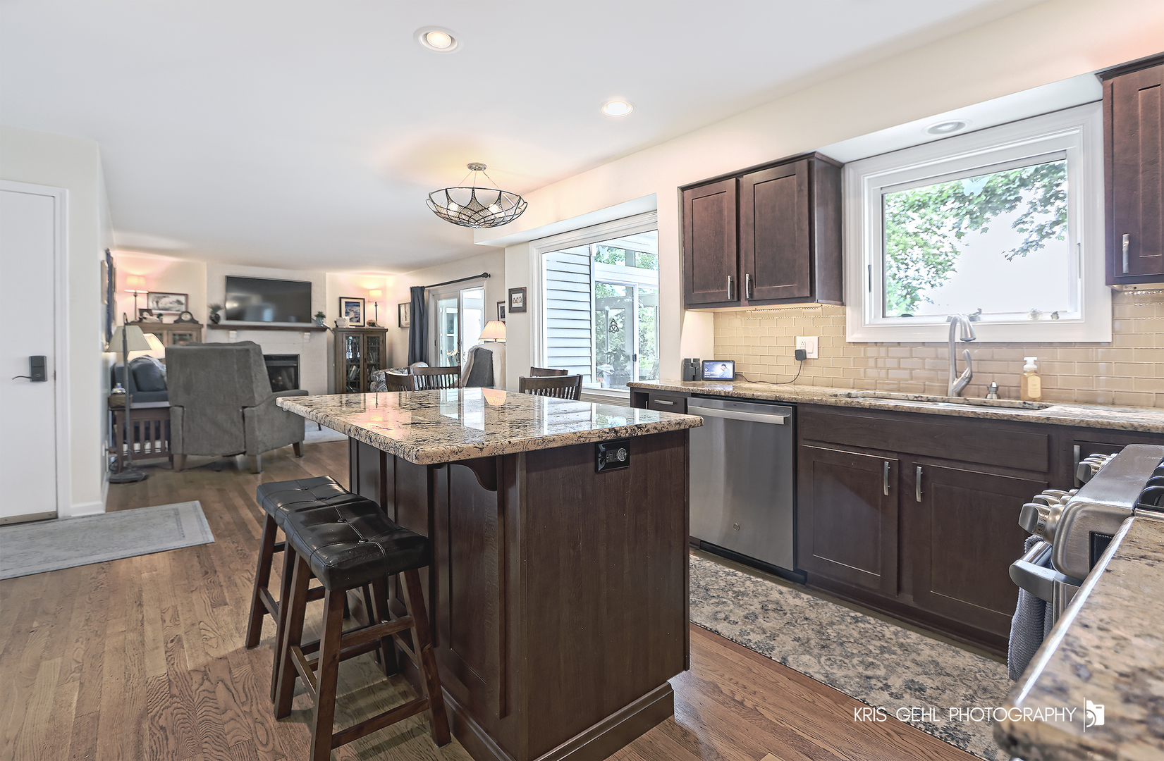 526 Whispering Pines Road Lindenhurst, IL 60046 - Photo 3 of 38 a kitchen with a sink dining table and chairs