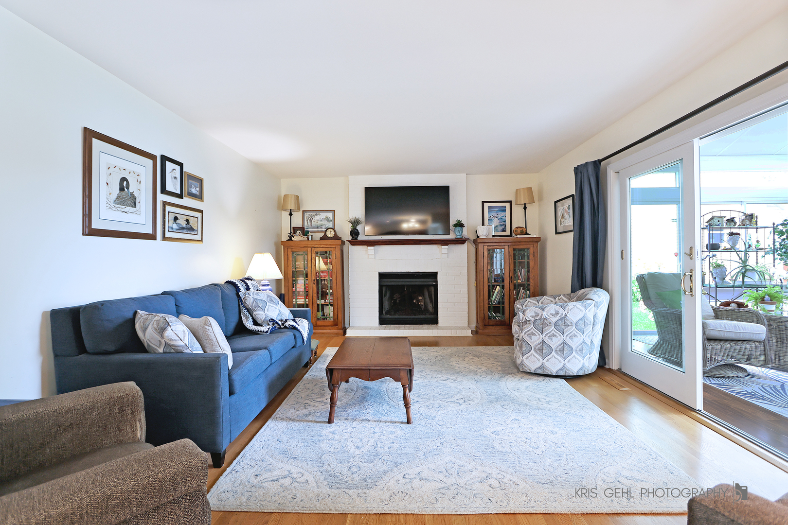 526 Whispering Pines Road Lindenhurst, IL 60046 - Photo 8 of 38 a living room with furniture a flat screen tv and a fireplace