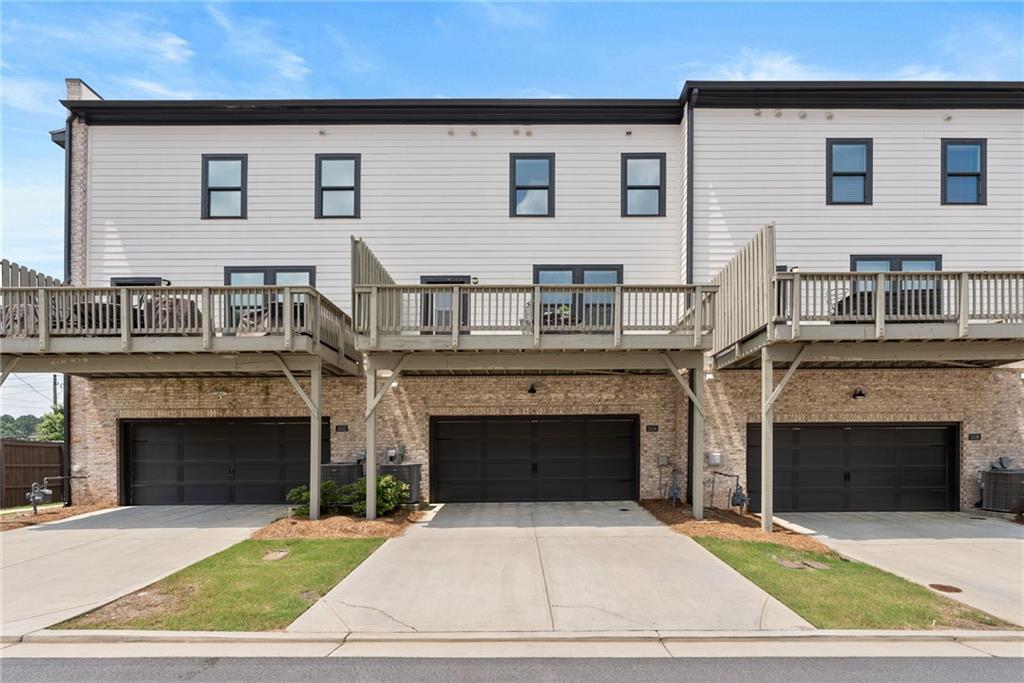 3334 Swallowtail Terrace Duluth, GA 30096 - Photo 14 of 37 a white building with a outdoor space
